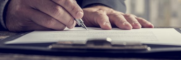 Close up on hand writing on notepad with pen