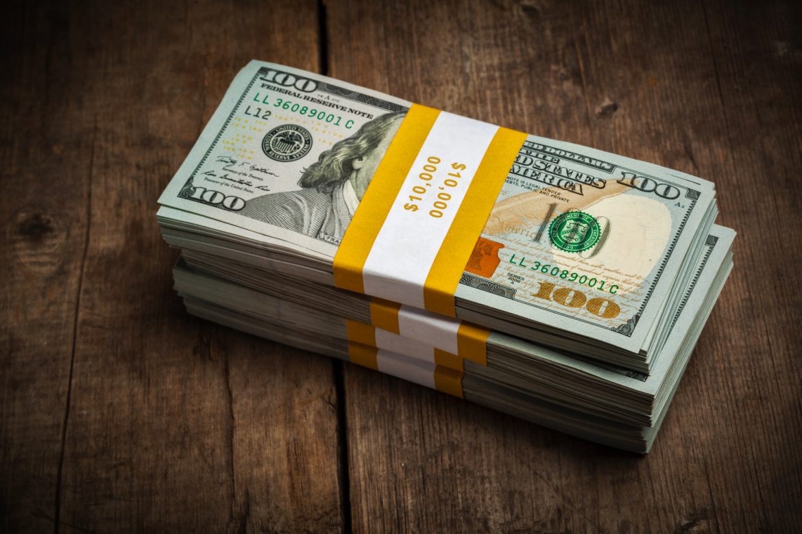 Stacks of 100 dollars banknotes bundles