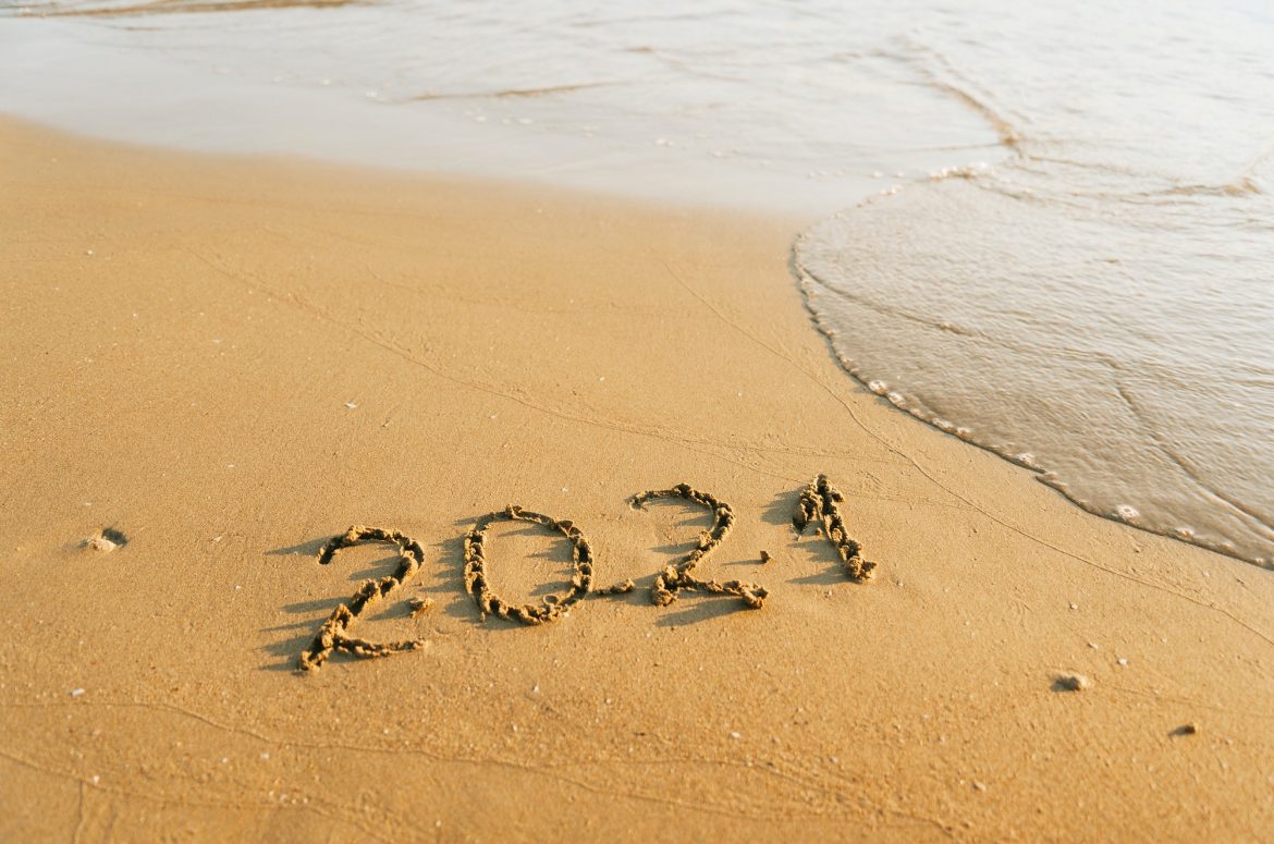 2021 inscription on sand near the sea